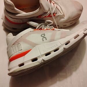 On Running White and Orange Sneakers